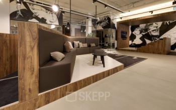 Stylish office space at Frederiklaan 10E, Eindhoven Strijp-S, featuring modern seating and wall art, ideal for office space rental.