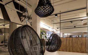 Stylish office space with hanging chairs and modern decor, located at Frederiklaan 10E in Eindhoven Strijp-S, ideal for office space rental.