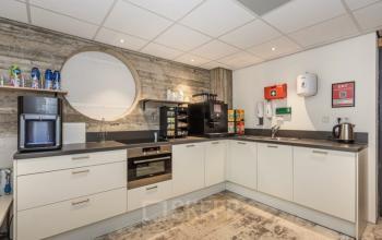 Modern pantry area at Brouwerijstraat 10 in Enschede, equipped with modern appliances, coffee machine, and ample storage space.