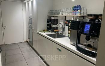 Small pantry with modern appliances, coffee machines, and shelves at Brouwerijstraat 10, Enschede.