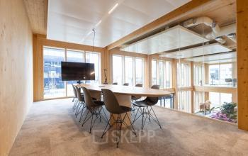 Bright office space at Moutlaan 1-23, Enschede, featuring a modern conference table and chairs, perfect for office space rental.