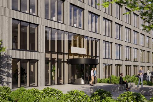 Modern exterior view of the office building at Moutlaan 1, Enschede, featuring large windows and a welcoming entrance. The surrounding greenery enhances the appeal of this office space rental location.