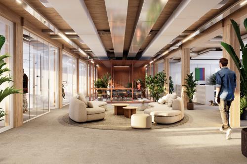 Modern office interior at Moutlaan 1-23, Enschede, featuring a spacious seating area with plush chairs and ceiling accents, perfect for office space rental.