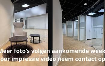 Modern office interior at Hoedemakerplein 2, Enschede, featuring elegant seating and glass partitions, perfect for office space rental.