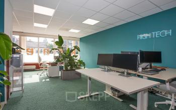 Bright, furnished office space rental at Boddenkampsingel 95, Enschede with modern desks, computers, and indoor plants, offering a comfortable workspace.