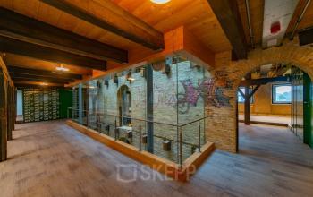 Interior view of office space at Prins Hendrikkade 3, Franeker, featuring exposed brickwork and a modern loft design ideal for rent office space needs.