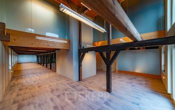Spacious office for rent at Prins Hendrikkade 3, Franeker, featuring rustic beams and natural lighting, ideal for dynamic office space rental.
