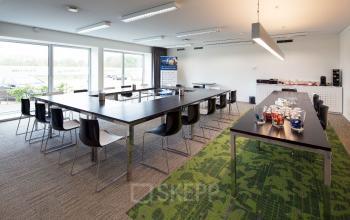 Spacious office interior at Transportlaan 1-151, Geleen, featuring long tables and chairs ideal for meetings, perfect for office space rental.