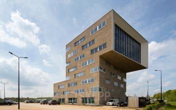 Modern office building at Transportlaan 1-151 in Geleen, featuring large windows and unique architecture suitable for office space rental.