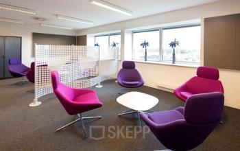 Modern office space with stylish purple chairs and partition screens available for rent in Geleen at Transportlaan 1-151.