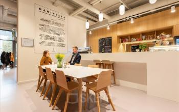 Modern gestalteter Büroraum mieten am Quai de l'Île 13 in Genf Innenstadt mit Personen bei einer Besprechung.