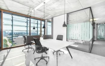 Moderne Büroraum mieten in Genf Les Genets, Rue du Pré-de-la-Bichette 1, mit bodentiefen Fenstern und stilvoller Einrichtung.