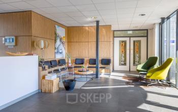 Reception area at Techniekweg 15, Gorinchem, with a mix of chairs and a front desk, ideal for welcoming guests. Office space rental available.