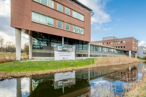 Exterior view of the office building located at Tielweg 30, Gouda, featuring modern design and ample windows, ideal for office space rental.