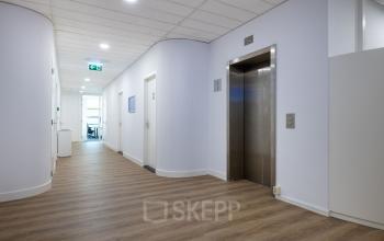 Bright office hallway at Groningenweg 8 8, Gouda, with elevator access. Ideal for office space rental.