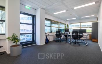 Office space rental at Groningenweg 8 8, Gouda, featuring modern desks and chairs in a well-lit environment.