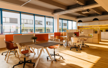 Modern office space rental at Waagner-Biro-Straße 47, Graz featuring a vibrant, well-lit interior with comfortable seating and ample workspace.