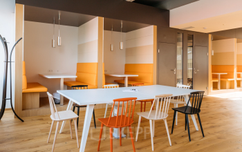 Contemporary office space rental at Waagner-Biro-Straße 47, Graz with modern furniture and warm color accents.