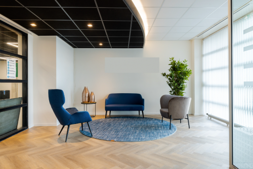 Modern office reception area at Atoomweg 6B, Groningen, featuring comfortable seating and stylish decor, ideal for office space rental.