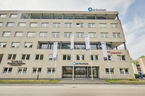 Exterior view of an office building at Leonard Springerlaan 7 in Groningen, showcasing available office space rental with large windows and modern facade.