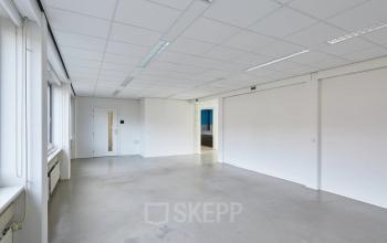 Spacious and bright office space for rent at Schweitzerlaan 12, Groningen, featuring plain walls and ceiling lights, ideal for customization.