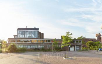Exterior view of the office building at Schweitzerlaan 12, Groningen, featuring a modern design ideal for office space rental.