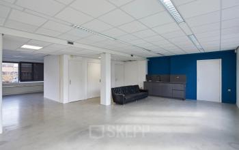 Spacious and bright office space at Schweitzerlaan 12, Groningen, available for rent. The office features a sleek kitchenette and ample natural light, ideal for efficient workspace rental.