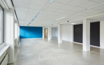 Unfurnished interior office space with large windows and colorful walls at Schweitzerlaan 12, ideal for rent office space in Groningen.