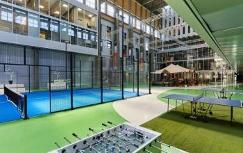 Spacious office at Helperpark 270-298 in Groningen featuring recreational amenities like a ping pong table, foosball, and a padel court, ideal for office space rental with leisure facilities.