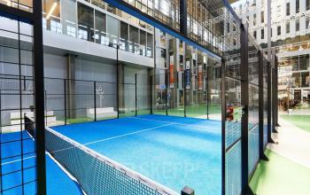 Spacious indoor area featuring a professional paddle court, ideal for employees to unwind during work breaks at Helperpark 270-298, Groningen. Perfect blend of recreational and office space rental options.