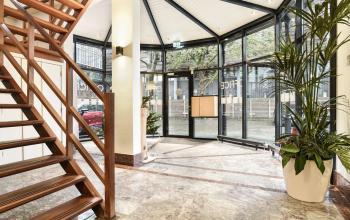 Spacious and well-lit entrance of an office space rental at Kennemerplein 20, Haarlem Centraal Station, showcasing modern design and architectural details.