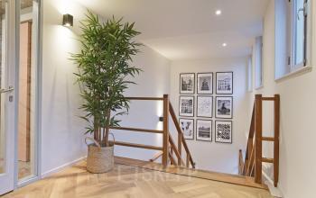 Spacious and well-lit office space rental at Kennemerplein 20, Haarlem Centraal Station, featuring a modern staircase and artistic decorations.