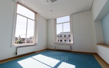 Bright, unfurnished office space with large windows for rent at Prinsen Bolwerk 1, near Haarlem Centraal Station.