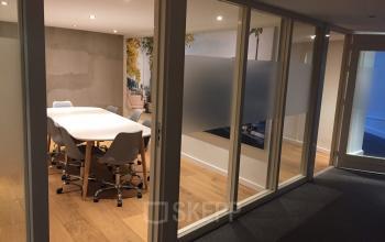 Conference room with a large white table and chairs at Staten Bolwerk 1, Haarlem Centraal Station, Haarlem, ideal for office space rental.