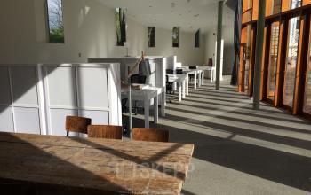 Bright office space at Staten Bolwerk 1, Haarlem Centraal Station with multiple workstations and large windows allowing ample natural light.