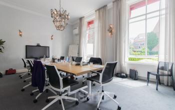 Elegant office space rental at Nieuwe Gracht 3, Haarlem Centrum, with a large table, chairs, and a TV for presentations.