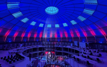 Spacious office space rental in Haarlem Centrum with a stunning dome ceiling and ambient lighting, perfect for an open floorplan setup.