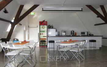 Spacious office pantry with modern appliances and seating area at Zijlstraat 76, Haarlem Centrum.