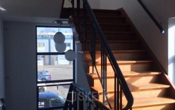 Interior view of a staircase with wooden steps and railings, located at Nijverheidsweg 50 in Haarlem Oost, nearby office space rental options.