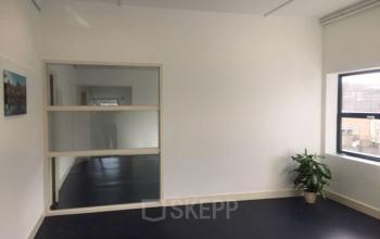 Spacious office interior for rent at Nijverheidsweg 50, Haarlem Oost, featuring natural light and a modern layout. Ideal for office space rental opportunities.