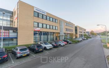 Exterior view of office building at Mollerusweg 84, Haarlem Waarderpolder, showcasing available office space rental opportunities with ample parking.