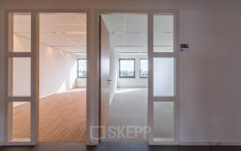 Bright office space with large windows and neutral tones at Mollerusweg 84, Haarlem Waarderpolder. Ideal for office space rental seekers.