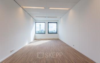 Bright, unfurnished office space available for rent at Mollerusweg 84, Haarlem Waarderpolder, featuring large windows with a view.