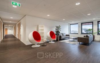 Spacious and modern office space for rent at Mollerusweg 84 in Haarlem Waarderpolder, featuring stylish seating and large windows allowing natural light.