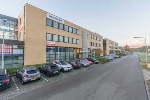 Exterior view of office building at Mollerusweg 84, Haarlem Waarderpolder, Haarlem with parking spaces and multiple parked cars in front.