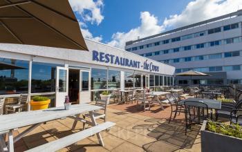 Exterior view of office building at A. Hofmanweg 5A, Haarlem Waarderpolder, featuring outdoor seating area of the restaurant 'The Crown'.