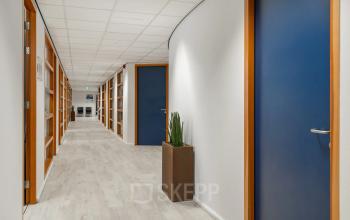 Bright hallway in an office space for rent at A. Hofmanweg 5A, Haarlem Waarderpolder, featuring modern doors and light wooden flooring.