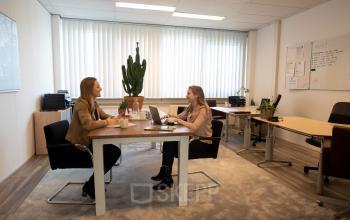 Two people having a meeting in a furnished office available for rent at Waarderweg 19, Haarlem Waarderpolder, highlighting office space rental opportunities.