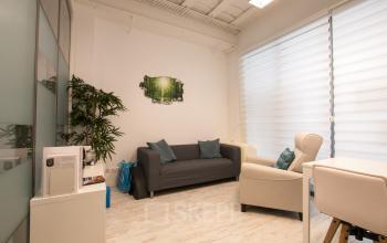 Bright office space rental at Waarderweg 19, Haarlem Waarderpolder, featuring a cozy seating area with a sofa and armchair. Ideal for those looking to rent office space with natural light.