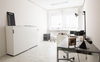 Bright office space at Waarderweg 19 in Haarlem Waarderpolder, with modern furnishings including a desk, chair, lamp, and cabinet, available for office space rental.